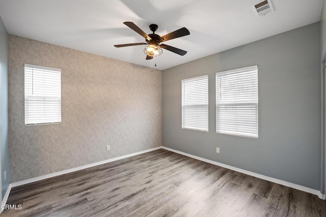 empty room featuring hardwood / wood-style floors and ceiling fan