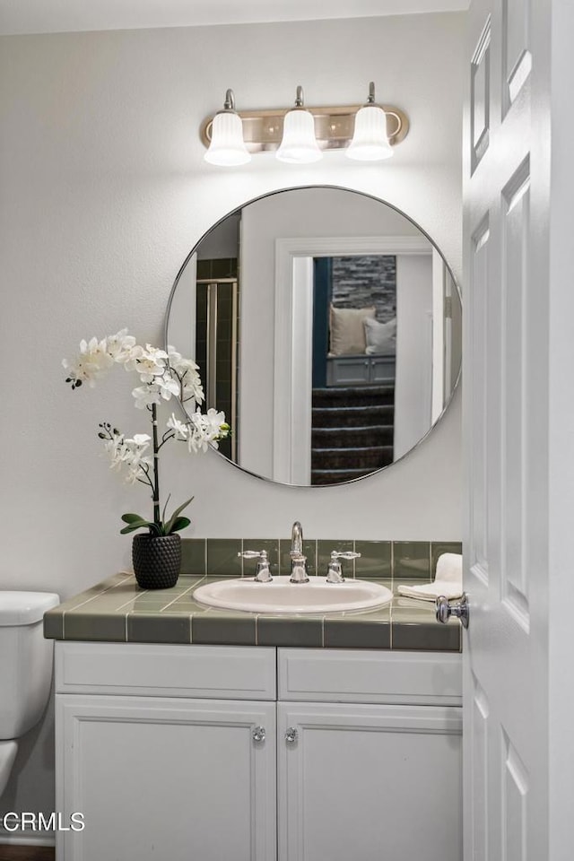 bathroom featuring vanity and toilet