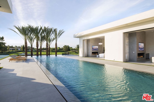 view of swimming pool featuring a patio area