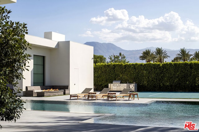 view of swimming pool featuring a patio and a mountain view