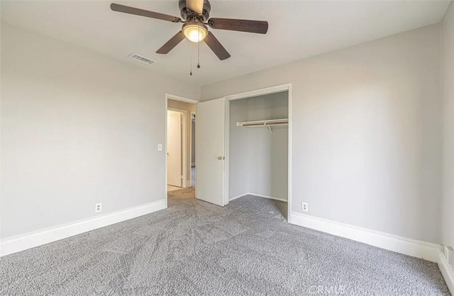 unfurnished bedroom with ceiling fan, light colored carpet, and a closet