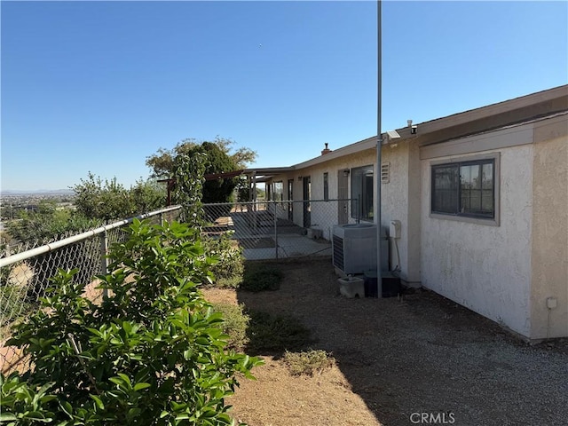 view of side of home featuring central AC unit