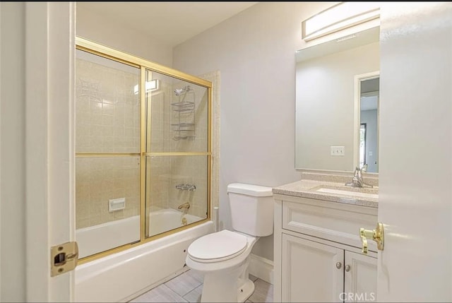 full bathroom with combined bath / shower with glass door, vanity, and toilet