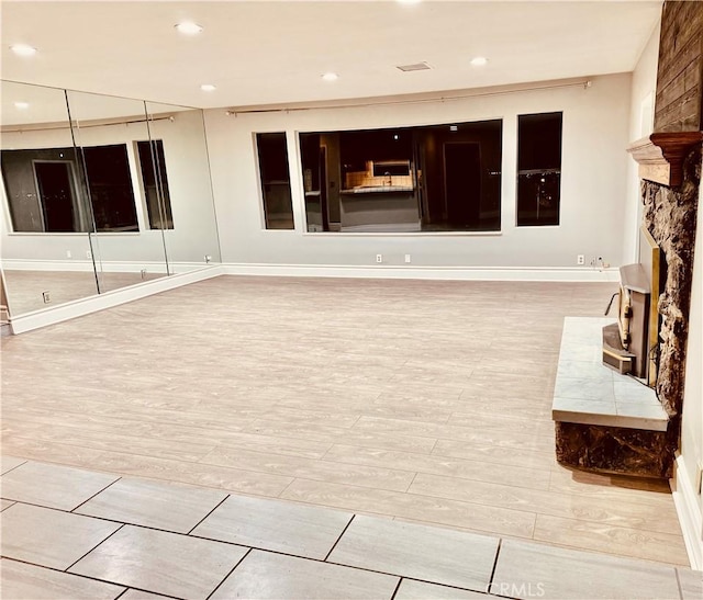 interior space with a fireplace and light hardwood / wood-style floors