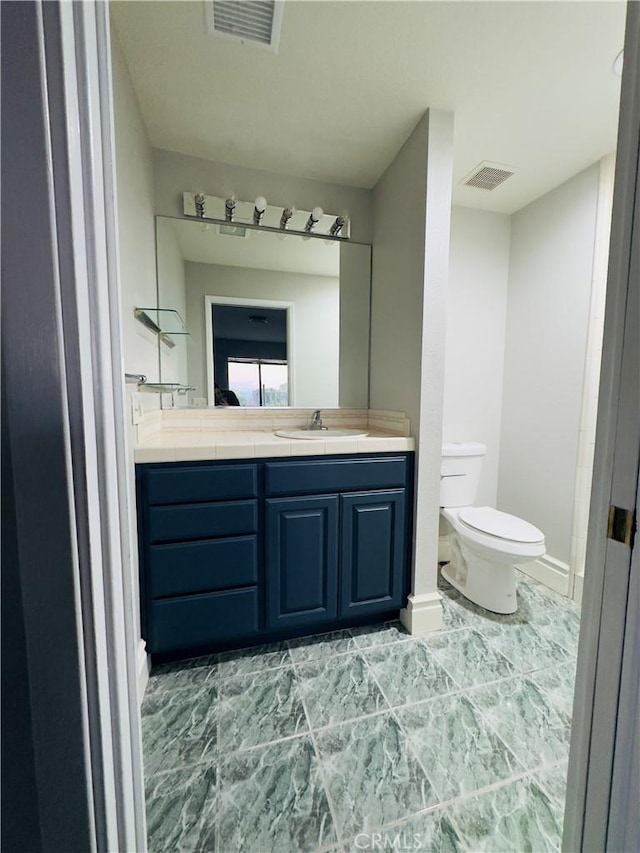 bathroom featuring vanity and toilet