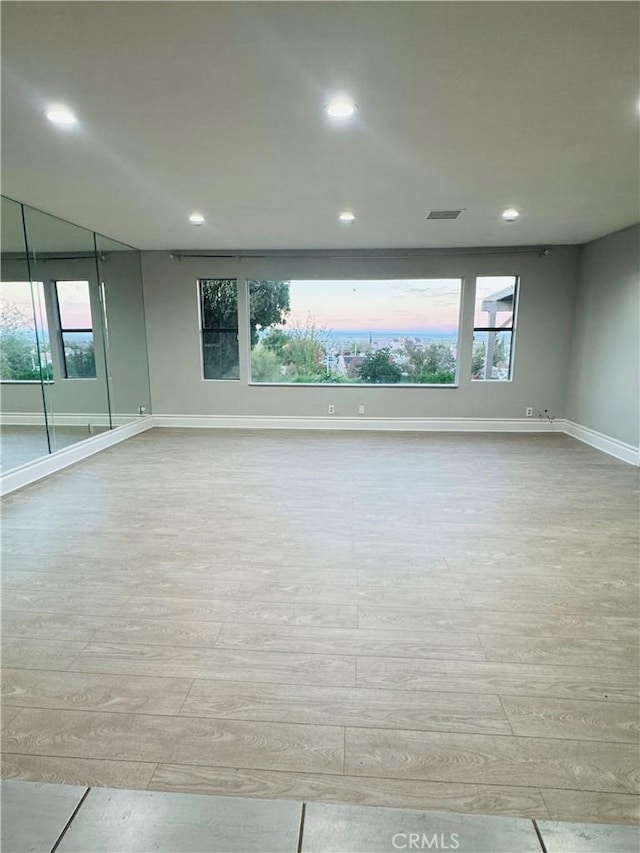 unfurnished room with light wood-type flooring