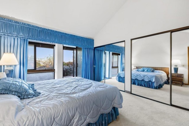 bedroom featuring light carpet and high vaulted ceiling