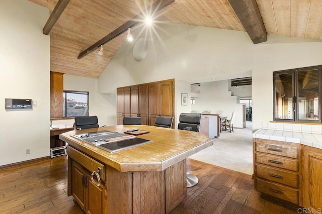 kitchen featuring wooden ceiling, dark hardwood / wood-style floors, lofted ceiling with beams, and a kitchen island