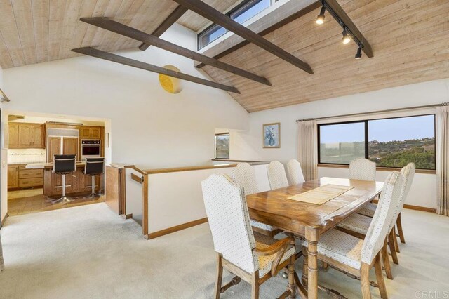 carpeted dining space featuring high vaulted ceiling, rail lighting, beamed ceiling, and wooden ceiling