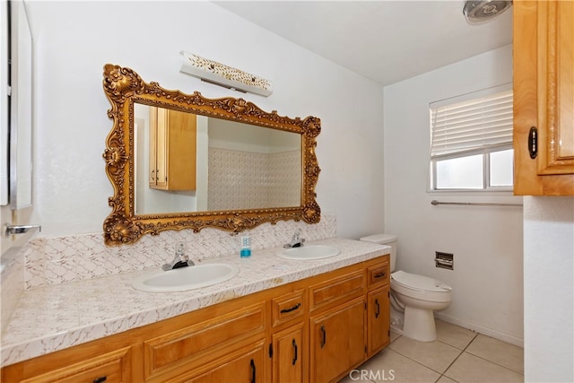 bathroom with tile patterned flooring, vanity, and toilet