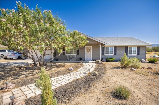 ranch-style home featuring a garage and a porch