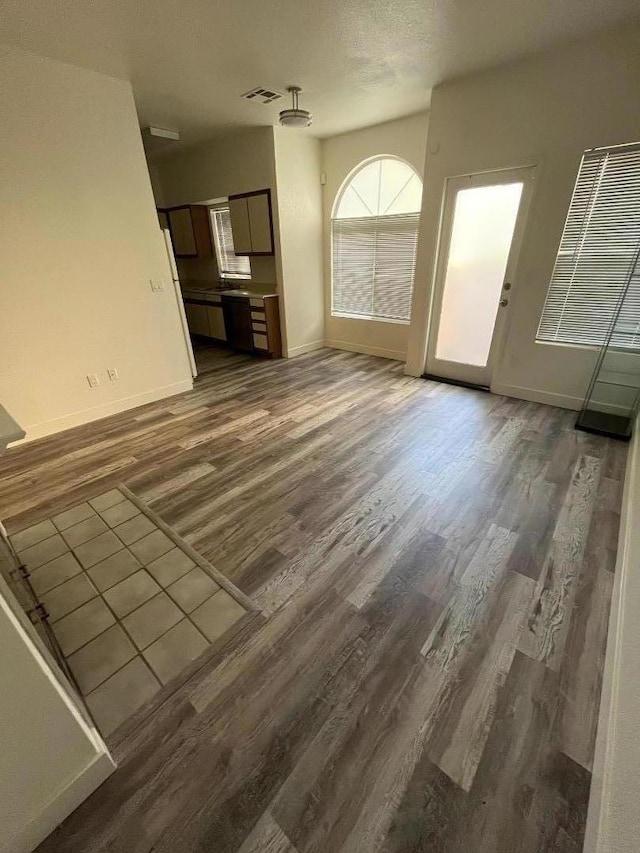 unfurnished living room featuring dark hardwood / wood-style flooring