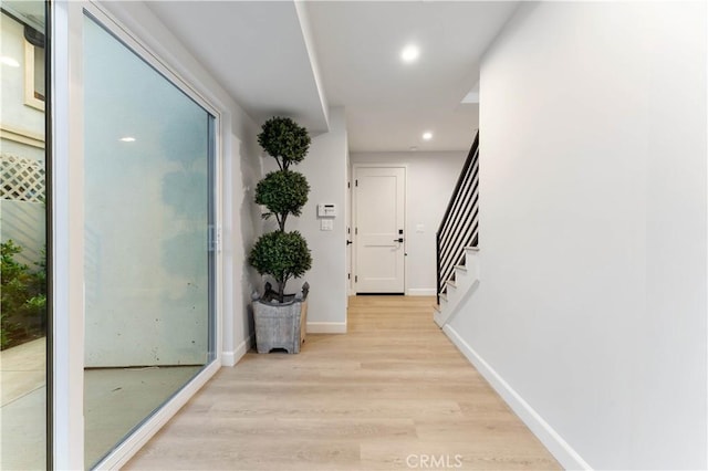 corridor with light hardwood / wood-style floors