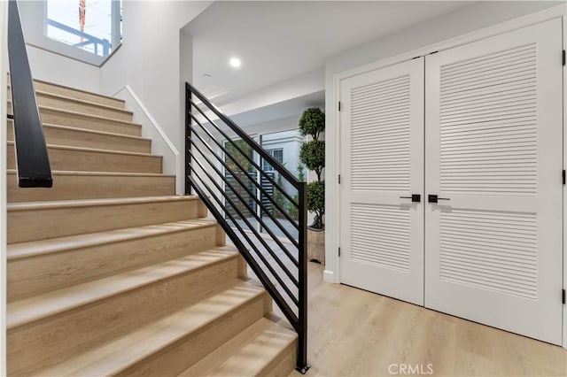 stairway with hardwood / wood-style floors