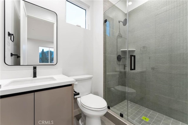 bathroom with vanity, toilet, and walk in shower