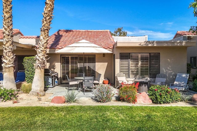 back of house featuring a yard and a patio