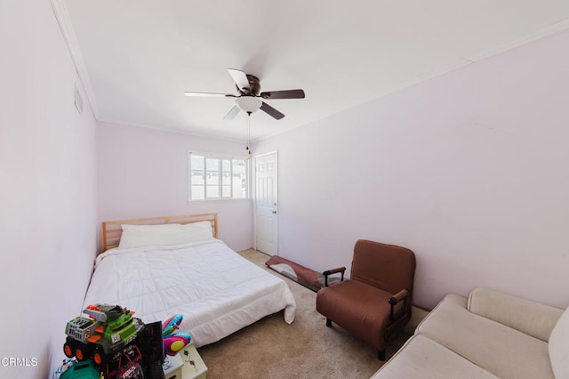 carpeted bedroom with crown molding and ceiling fan