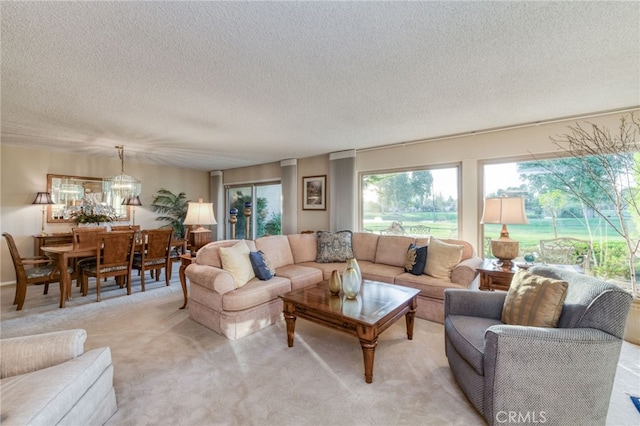 carpeted living room featuring a textured ceiling and a notable chandelier