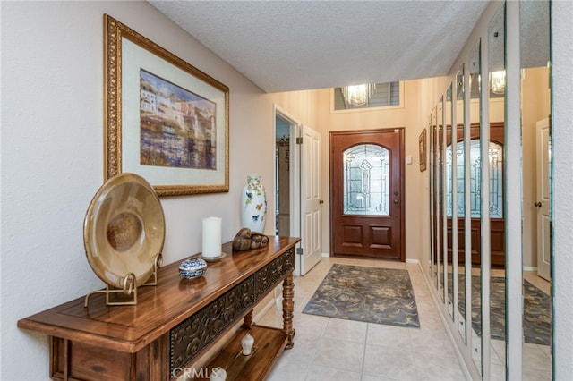 tiled entrance foyer featuring a textured ceiling