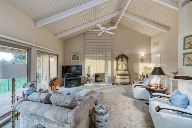 carpeted living room with a fireplace, high vaulted ceiling, beamed ceiling, and ceiling fan