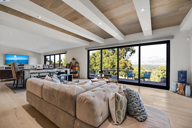 living room with vaulted ceiling with beams, light hardwood / wood-style flooring, and wood ceiling