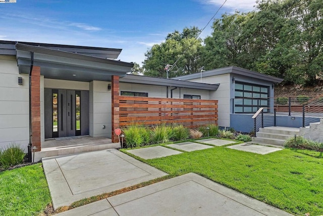 exterior space featuring french doors and a lawn