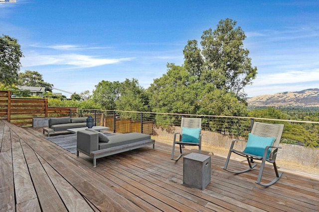 wooden deck with outdoor lounge area and a mountain view