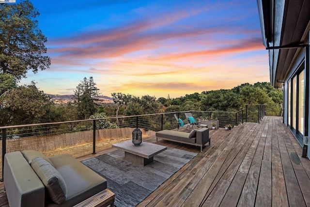 deck at dusk featuring an outdoor living space