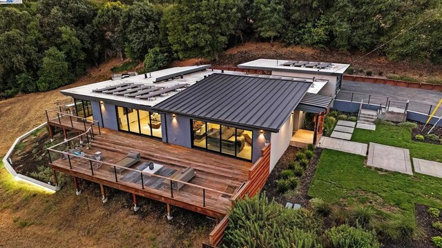 back of house featuring an outdoor living space and a deck