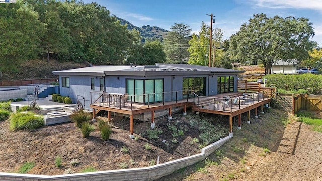 back of property with a wooden deck