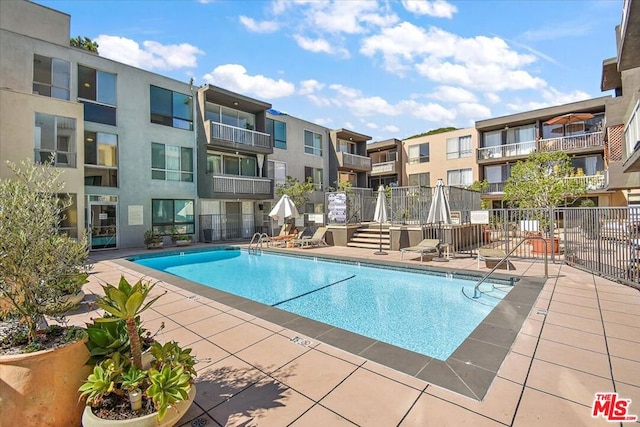 view of swimming pool featuring a patio