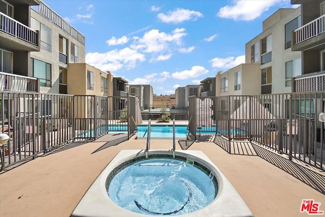 view of pool with a community hot tub