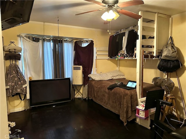 bedroom with ornamental molding, hardwood / wood-style flooring, and ceiling fan