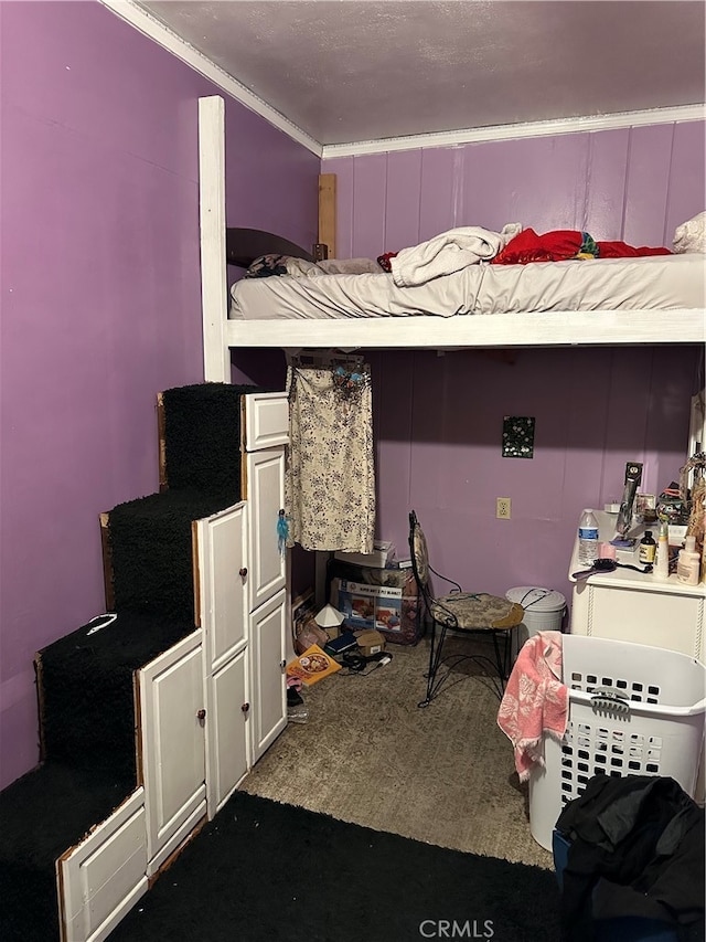 bedroom featuring ornamental molding and carpet flooring