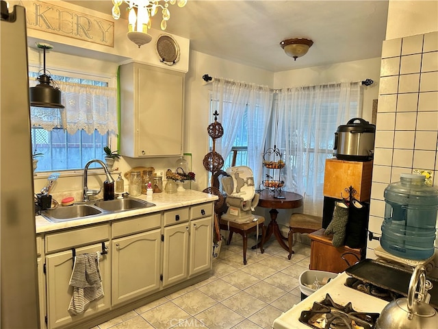 kitchen featuring sink and light tile patterned flooring