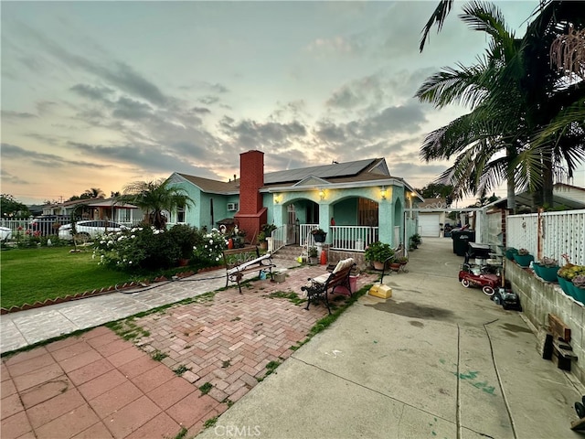 bungalow-style house with covered porch and a lawn