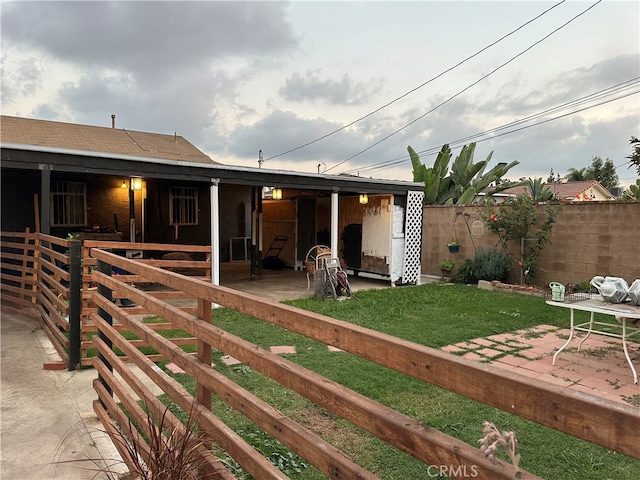 rear view of property with a patio area and a lawn