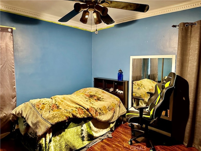 bedroom with ornamental molding, dark hardwood / wood-style floors, and ceiling fan