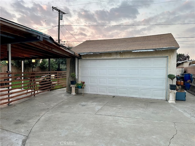 view of garage at dusk