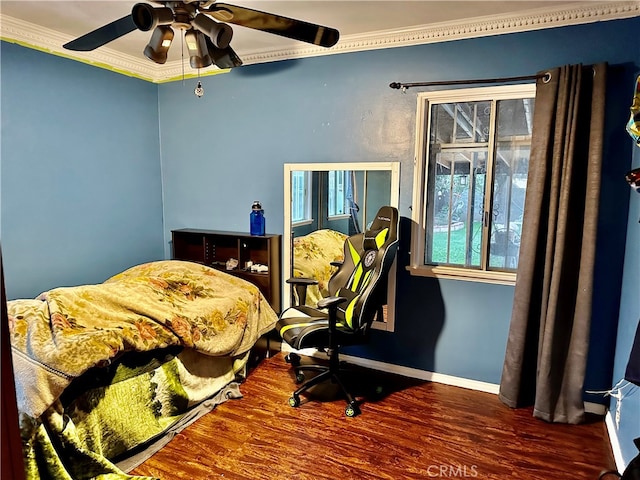 bedroom featuring hardwood / wood-style flooring, ceiling fan, and crown molding