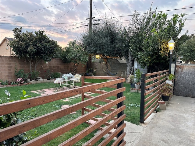 gate at dusk with a yard