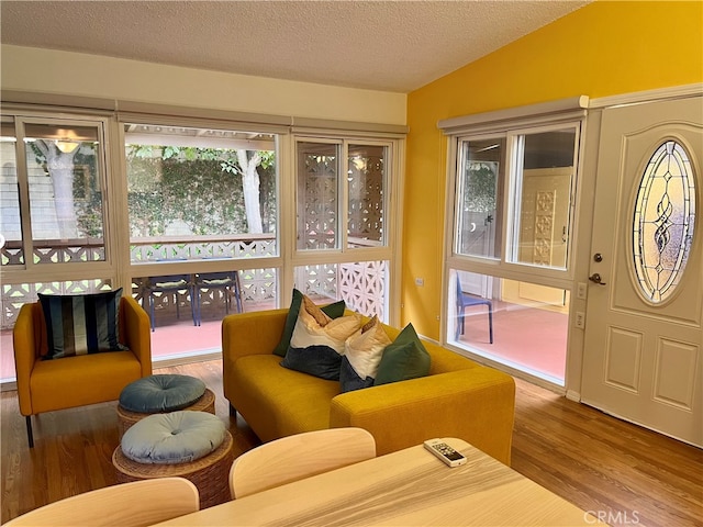 sunroom featuring vaulted ceiling