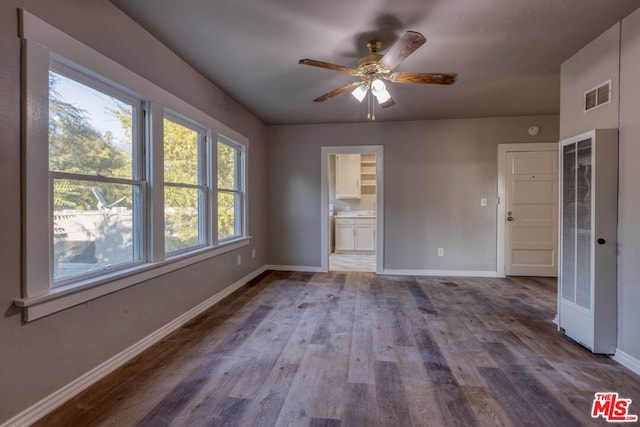 spare room with ceiling fan and hardwood / wood-style flooring