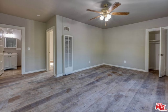 unfurnished bedroom with ceiling fan, a closet, and light hardwood / wood-style floors