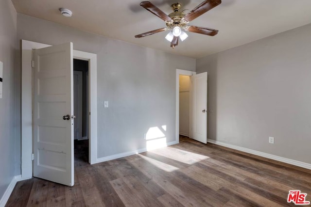 unfurnished bedroom with ceiling fan and wood-type flooring