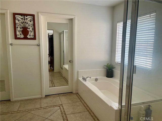 bathroom featuring tile patterned floors and shower with separate bathtub