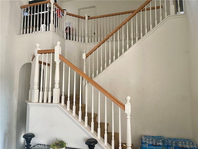 stairs featuring a towering ceiling