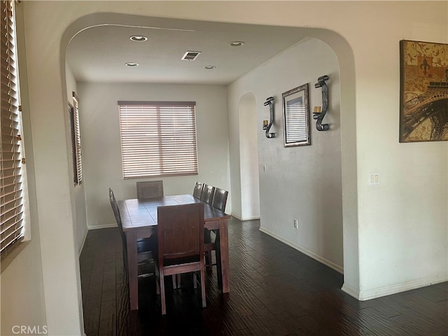 dining space featuring dark wood-type flooring