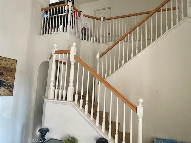 stairway featuring a high ceiling