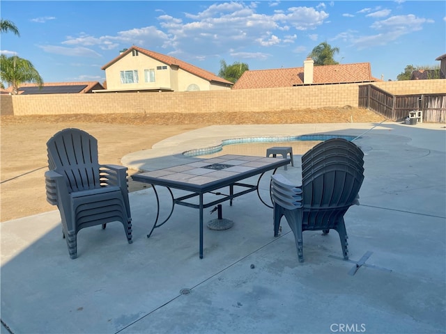 view of patio with an empty pool